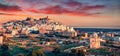 Panoramic evening cityscape of Ostuni town. Majestic summer sunset on Apulia, Italy, Europe.