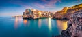 Panoramic evening cityscape of Polignano a Mare town, Puglia region, Italy, Europe. Amazing spring sunrise view of Adriatic sea. Royalty Free Stock Photo