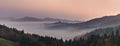 Panoramic foggy landscape at dawn over mountain and valley