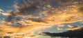 Panoramic golden sunset with dramatic clouds