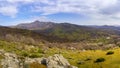 Panoramic green landscape with blue sky with clouds and high mountains in the background. Sierra del RincÃÂ³n Madrid Royalty Free Stock Photo