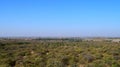 Panoramic Green Landscape of a Prosopis Juliflora forest captured from a Hill - A Natural Background with Blue Sky Royalty Free Stock Photo