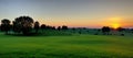 Panoramic Green Meadow Landscape At Sunset For Background