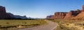 Panoramic. The Highway Leading In To Canyonlands, Utah. Blue Sky, Red Rocks, Green Grass, Remote Location Royalty Free Stock Photo