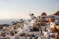 Panoramic iconic view from Oia village with Windmill on Santorini island, Greece. The place for text included. Royalty Free Stock Photo