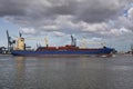 Panoramic image of a container ship passing cranes in Rotterdam Royalty Free Stock Photo