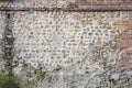 Panoramic image of a Decorative old and red brick flint wall with green and yellow vegetable moss Royalty Free Stock Photo