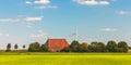 Panoramic image of a Dutch farm with wind turbines