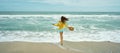 Panoramic image ocean beach with waves and sky, rear view woman enjoying seascape