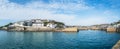 Panoramic image of Porthleven Harbour on a sunny day with a blue sky soft white clouds Royalty Free Stock Photo