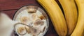 Panoramic image of preparation banana smoothie, pouring milk in a blender