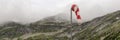 Panorama, red and white wind cone with mountains in the background Royalty Free Stock Photo