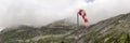 Panorama, red and white wind cone with mountains in the background Royalty Free Stock Photo