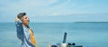Panoramic image relaxed man freelancer enjoying morning by sea at beach.