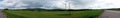 Panoramic image of road though fields Royalty Free Stock Photo