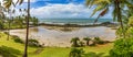 Panoramic image of a small deserted beach surrounded by coconut trees Royalty Free Stock Photo