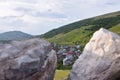 Panoramic image of a small mountain village with view of hills and meadows