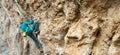 Panoramic image strong woman rock climber climbing on beautiful texture rock wall Royalty Free Stock Photo