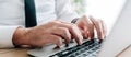 Panoramic image of white collar businessman hands typing laptop computer keyboard in business office Royalty Free Stock Photo