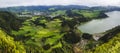 Panoramic landscape with aerial view on beautiful blue green crater lake Lagoa das Furnas and village Furnas with Royalty Free Stock Photo