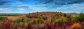 Landscape of autumn hills with colorful trees and dramatic sky Royalty Free Stock Photo