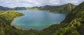 Panoramic landscape with beautiful blue crater lake Lagoa do Fogo from top of the hill on hiking trail. Lake of Fire is Royalty Free Stock Photo