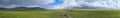 Panoramic landscape of beautiful green mountain valley with blue cloudy sky on background. Spring farm field landscape. Outdoor la Royalty Free Stock Photo