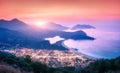 Panoramic landscape with blue lagoon, sea, city lights, mountains
