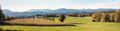 Panoramic landscape Irschenberg, with view to Wilparting church and alpine foothills Royalty Free Stock Photo