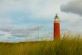 Panoramic landscape with the lighthouse of Cocksdorp with grass dunes in the forground, Nationalpark Duinen van Texel, Texel islan Royalty Free Stock Photo