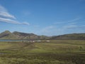 Landscape with mountain huts at camping site on blue Alftavatn lake with river, green hills and glacier in beautiful Royalty Free Stock Photo