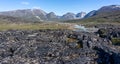 Panoramic landscape of mountains and meltwater river at Camp Frieda on the Disko Bay coast, Greenland