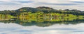 Panoramic landscape in region Allgaeu with alps mountain range mirroring symmetric in lake Royalty Free Stock Photo