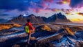 Panoramic landscape at sunrise. Backpacker standing at Vestrahorn mountains in Stokksnes, Iceland