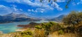 Panoramic landscape of turquoise lake with mountains and hills in andalusia with road meadows and bushes