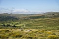 Panoramic landscape view across Dartmoor National Park in Summer with wide views of several tors and valleys Royalty Free Stock Photo