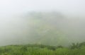 Panoramic landscape view of beautiful lush scenic Sahyadri mountains through dense fog. The view is as seen from Sinhagad in Pune Royalty Free Stock Photo