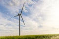 Panoramic landscape view of new white modern wind turbine farm power generation station against clear blue sky canola Royalty Free Stock Photo