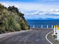 Panoramic landscape with view of road on cliff at the edge of lake in spring and sunny day Royalty Free Stock Photo