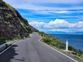 Panoramic landscape with view of road on cliff at the edge of lake in spring and sunny day Royalty Free Stock Photo