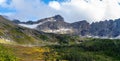 Panoramic landscape view of snow capped mountains and autumn color trees Royalty Free Stock Photo