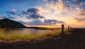 Panoramic landscape  view of sunset or sunrise sky clouds over lake dam mountain and asphalt road. Concept of country side Royalty Free Stock Photo