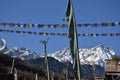 Panoramic landscape view of tibetan prayer flags raised in Lachen with snowcapped great Himalayas in the background in North Royalty Free Stock Photo