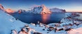Panoramic landscape, winter mountains and fjord reflection in water. Norway, the Lofoten Islands. Colorful winter sunset.