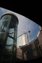 Panoramic lift with glass facade. In the background the Pirelli skyscraper in Milan. Central Station