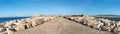 Panoramic of lighthouse at the end of the asphalt road at sea Royalty Free Stock Photo