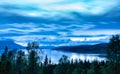 Panoramic, long exposure photo 25 sec of heavy clouds over Norwegian mountains around Rossvatnet Lake, Northern Norway. Early Royalty Free Stock Photo