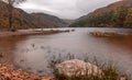 Panoramic long exposure view, silky water during autumn in the Wicklow Mountains. Rock on front, Glendalough Upper lake