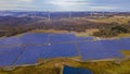 Panoramic low aerial view of the hybrid Gullen Solar Farm and Gullen Range Wind Farm at Bannister in NSW, Australia