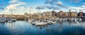 Panoramic marina with many small sailing boats docked on the shore of the city of Gijon, Asturias, Spain. Royalty Free Stock Photo